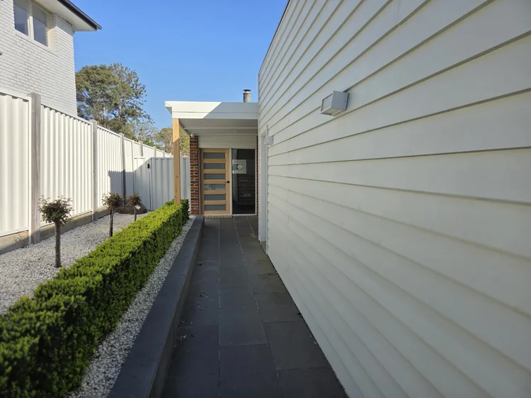 The path alongside the building leading to the clinic door.