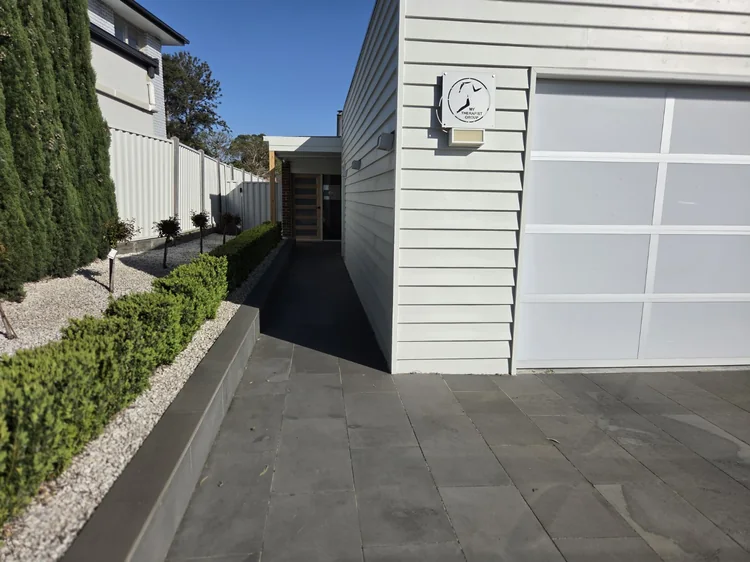 The clinic sign beside the path leading to the entrance.