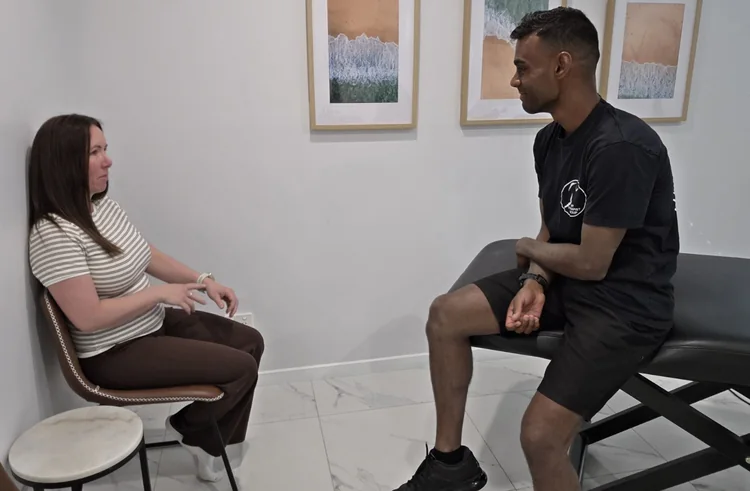 Ash listening during a one-to-one consultation in the clinic.