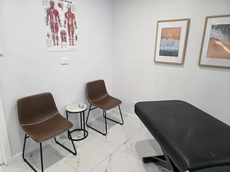 Consultation chairs beside the treatment table in the clinic.