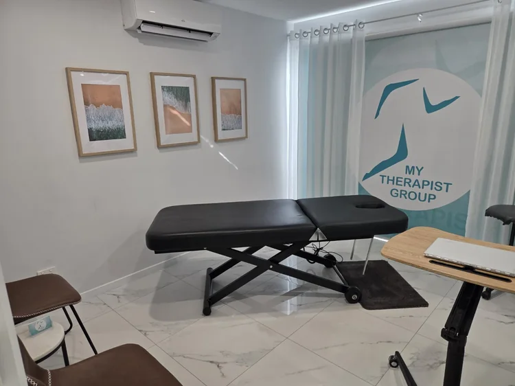 The treatment room with the physiotherapy table and My Therapist Group sign.